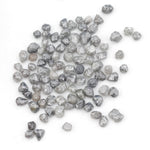 grey black natural diamond with a rugged raw surface and uncut profile