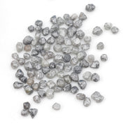 grey black natural diamond with a rugged raw surface and uncut profile