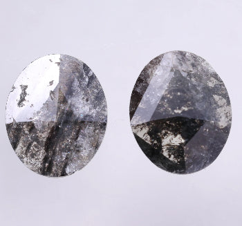 Pair of oval-shaped salt and pepper diamond on a light gray background
