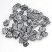 black raw diamond with a natural uncut rough surface for jewelry design projects