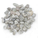 light grey raw diamond with an uncut rough profile for jewelry creation