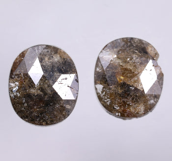 Two oval-shaped diamonds on a light gray background