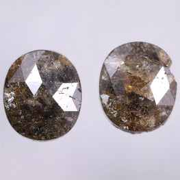 Two oval-shaped diamonds on a light gray background