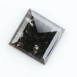 Sqaure step cut salt and pepper lab grown diamond with galaxy-like black and white inclusions, featuring a geometric faceted shape and transparent edges, ideal for unique engagement rings or custom jewelry designs
