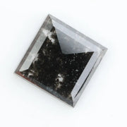 Sqaure step cut salt and pepper lab grown diamond with galaxy-like black and white inclusions, featuring a geometric faceted shape and transparent edges, ideal for unique engagement rings or custom jewelry designs