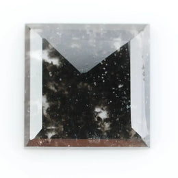 Sqaure step cut salt and pepper lab grown diamond with galaxy-like black and white inclusions, featuring a geometric faceted shape and transparent edges, ideal for unique engagement rings or custom jewelry designs