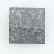 Sqaure step cut salt and pepper lab grown diamond with galaxy-like black and white inclusions, featuring a geometric faceted shape and transparent edges, ideal for unique engagement rings or custom jewelry designs