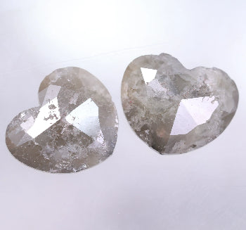 Two heart-shaped diamonds on a light gray background
