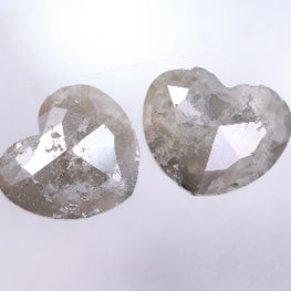 Two heart-shaped diamonds on a light gray background