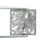 Sqaure step cut salt and pepper lab grown diamond with galaxy-like black and white inclusions, featuring a geometric faceted shape and transparent edges, ideal for unique engagement rings or custom jewelry designs