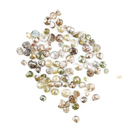 Natural multi colour rough diamonds with yellow, grey, champagne and white tones displayed on white background.