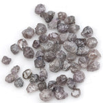 fancy pink raw diamond showing a natural rough surface for gold jewelry design