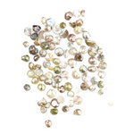 Natural multi colour rough diamonds with yellow, grey, champagne and white tones displayed on white background.