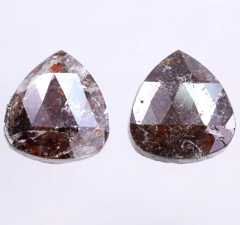 Two teardrop-shaped diamonds on a light purple background