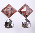 Pair of earrings with square and teardrop-shaped diamond on a light gray background