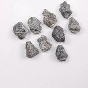 Close-up view of a sparkling gray diamond in a white gold setting.