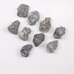 Close-up view of a sparkling gray diamond in a white gold setting.