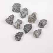 Close-up view of a sparkling gray diamond in a white gold setting.