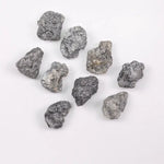 Close-up view of a sparkling gray diamond in a white gold setting.