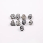 Close-up view of a sparkling gray diamond in a white gold setting.