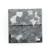 Premium lab-grown diamond with radiant square cut and distinctive black inclusions, offering a unique and sustainable choice for fine jewelry.
