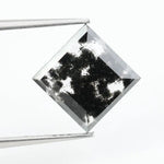 Premium lab-grown diamond with radiant square cut and distinctive black inclusions, offering a unique and sustainable choice for fine jewelry.