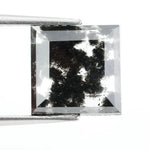 Premium lab-grown diamond with radiant square cut and distinctive black inclusions, offering a unique and sustainable choice for fine jewelry.