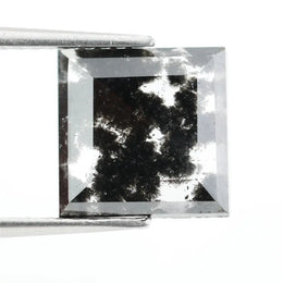 Premium lab-grown diamond with radiant square cut and distinctive black inclusions, offering a unique and sustainable choice for fine jewelry.
