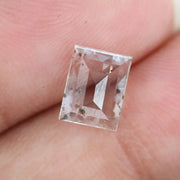 Emerald cut lab grown diamond loose stone with high clarity and subtle natural inclusions, transparent and ethically created for engagement ring or fine jewelry use