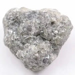 A close-up view of a grey diamond showcasing its unique salt-and-pepper appearance with visible mineral inclusions.
