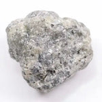 A close-up view of a grey diamond showcasing its unique salt-and-pepper appearance with visible mineral inclusions.