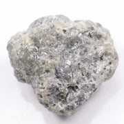 A close-up view of a grey diamond showcasing its unique salt-and-pepper appearance with visible mineral inclusions.