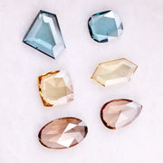 Fancy color lab grown diamonds in blue, yellow and champagne tones featuring cushion, oval, pear and geometric rose cut loose stones for custom jewelry.