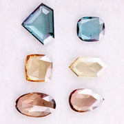 Fancy color lab grown diamonds in blue, yellow and champagne tones featuring cushion, oval, pear and geometric rose cut loose stones for custom jewelry.