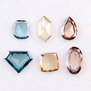 Fancy color lab grown diamonds in blue, yellow and champagne tones featuring cushion, oval, pear and geometric rose cut loose stones for custom jewelry.