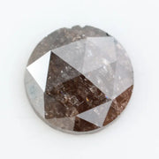Close-up of a premium round cut brown lab-grown diamond with sparkling facets, showcasing eco-friendly, conflict-free quality and unique natural-like inclusions.