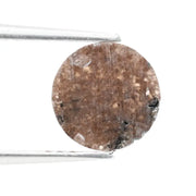 Close-up of a premium round cut brown lab-grown diamond with sparkling facets, showcasing eco-friendly, conflict-free quality and unique natural-like inclusions.
