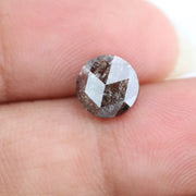 Close-up of a premium round cut brown lab-grown diamond with sparkling facets, showcasing eco-friendly, conflict-free quality and unique natural-like inclusions.