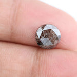 Close-up of a premium round cut brown lab-grown diamond with sparkling facets, showcasing eco-friendly, conflict-free quality and unique natural-like inclusions.