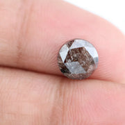 Close-up of a premium round cut brown lab-grown diamond with sparkling facets, showcasing eco-friendly, conflict-free quality and unique natural-like inclusions.