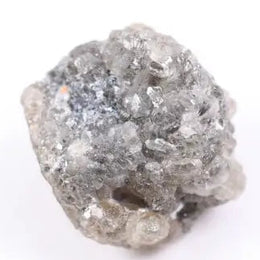 A side view of a grey diamond engagement ring, featuring the gem's distinctive speckles and smoky hues, set in platinum.