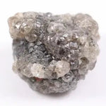 A side view of a grey diamond engagement ring, featuring the gem's distinctive speckles and smoky hues, set in platinum.