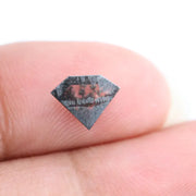 Geometric cut salt and pepper lab grown diamond with smoky black and white inclusions, showcasing a unique faceted shape and modern ethical gemstone design on a clean white background
