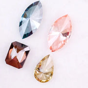 Set of four fancy color lab grown diamonds including emerald cut brown, pear shape yellow, marquise blue and pink loose diamonds for custom fine jewelry