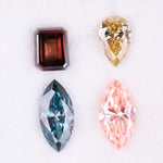 Set of four fancy color lab grown diamonds including emerald cut brown, pear shape yellow, marquise blue and pink loose diamonds for custom fine jewelry