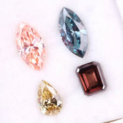 Set of four fancy color lab grown diamonds including emerald cut brown, pear shape yellow, marquise blue and pink loose diamonds for custom fine jewelry