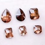 Set of premium brown lab-grown diamonds in emerald, pear, and octagon cuts displaying rich fancy color and brilliant faceting for custom fine jewelry designs.