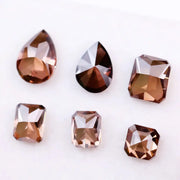 Set of premium brown lab-grown diamonds in emerald, pear, and octagon cuts displaying rich fancy color and brilliant faceting for custom fine jewelry designs.