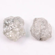 Natural rough gray diamond pair featuring raw, uncut beauty.