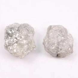 Natural rough gray diamond pair featuring raw, uncut beauty.
